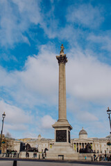 London's iconic Trafalgar Square is captured with its towering Nelson's Column monument, a central landmark surrounded by grand architecture and the vibrant energy of the city.