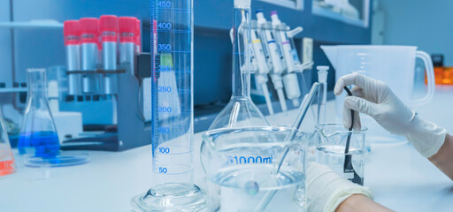 Scientist mix chemicals with The shake machine Before the experiment.Mixture laced with samples into test tubes,Thailand scientist working in the lab
