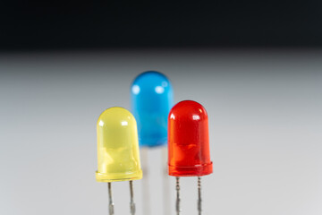 Yellow Red and Blue LED parts in scientific experimental setup as macro shot on white and black...