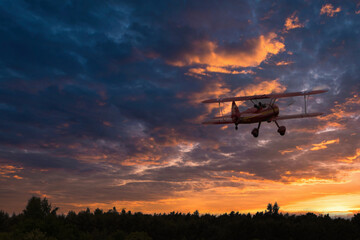 Historic biplane starts in sunset © Stefan
