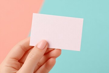 Fototapeta premium hand holding paper card with promotional code on minimalistic pastel background