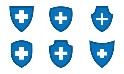 Obraz premium Blue shield with a medical cross on white background