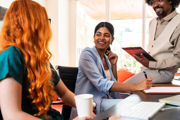 Fototapeta premium Multiethnic small group of businesspeople meeting in a coworking company office