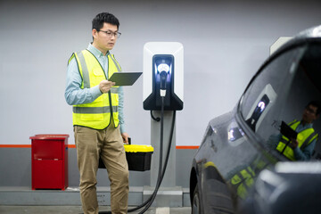 asian Male engineer working with digital tablet in charging station