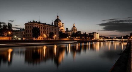 Fototapeta premium Serene Black and White Nighttime View of Historic Cityscape with Reflections on the River