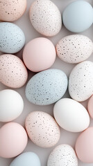 Pastel Colored Eggs with Speckles Arranged on a Light Background for Easter Celebration