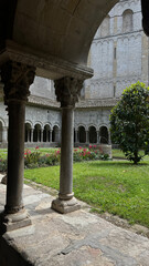 Cloistered Courtyard with Arches and Columns. Cloistered Courtyard with Stone Arches and Columns in a Monastery. Girona, Spain