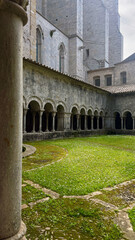Cloistered Courtyard with Arches and Columns. Cloistered Courtyard with Stone Arches and Columns in a Monastery. Girona, Spain