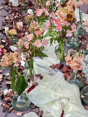 Elegant floral table setting with pink flowers and romantic decor. Floral Table Decor with Pink and Dried Flowers