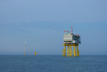 Offshore Substation and Wind Turbine in Open Sea During Renewable Energy Development, Wind Farm Construction Maintenance