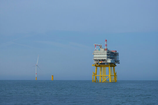 Offshore Substation and Wind Turbine in Open Sea During Renewable Energy Development, Wind Farm Construction Maintenance