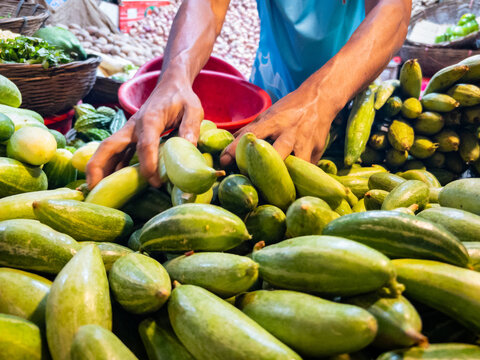 Bangladeshi Street Vendor Selling Vegetables to a Customer