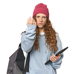 Redhead student with tablet showing fist to camera, aggressive facial expression.