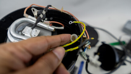 Electric coffee maker disassembled for maintenance