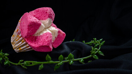 Pink blooming steamed sponge cake with soft texture, equipped with green leaves for decoration on...