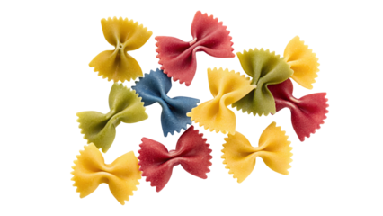 A close up shot of colorful farfalle pasta scattered on a white background in a random arrangement