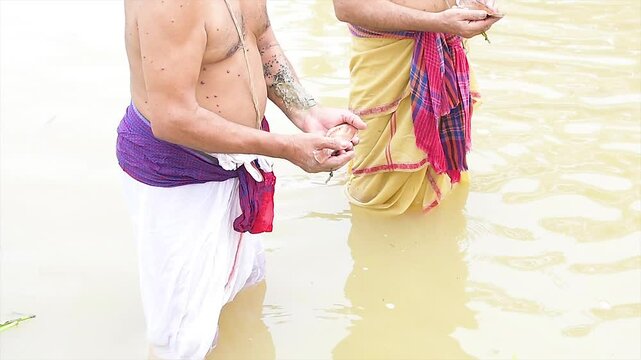 Tarpan is being performed by Indian hindu devotees on the banks of the holy river Ganga in India. Tarpan - It is a Hindu ritual, the sacrament of offering drinking water to the manes.
