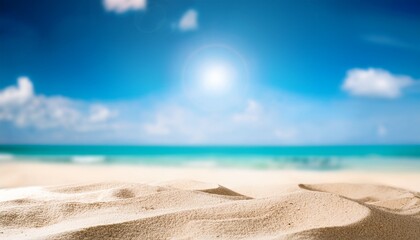 summer beach blurred background with blue sky and sand