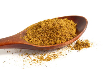 Wooden spoon with curry spice lies on white background.	