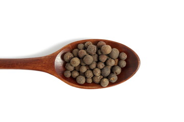 On a white background lies a pile of allspice peas.	