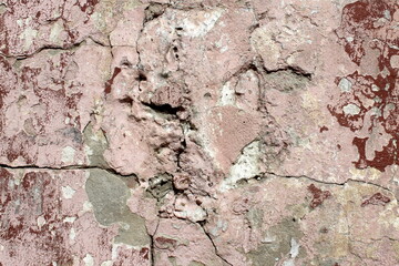 Abstract background of a dilapidated wall with cracked plaster.