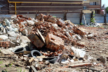 A pile of construction waste lies around in the summer.