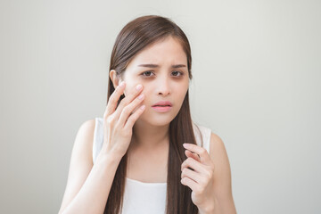 Bored, insomnia asian young woman, girl looking at camera, hand touching under eyes with problem of...