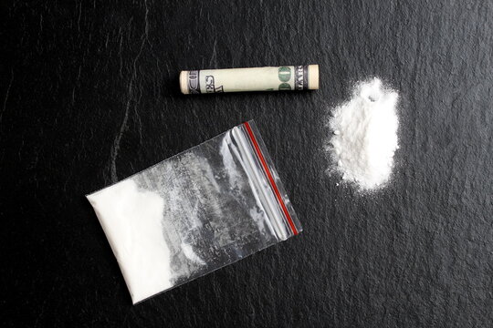 There is a bag of drugs on a black background.