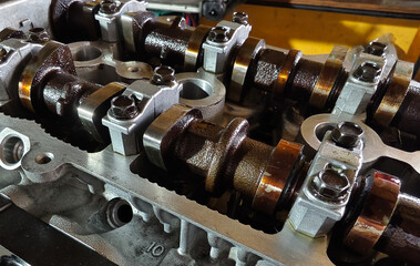 A car engine is being worked on inside a garage workshop