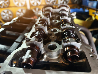 A car engine is being worked on inside a garage workshop