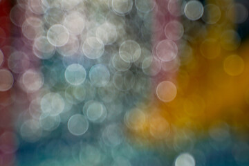 Abstract nature background with colorful bokeh from sunlight hitting water drops splashing from colorful water park rides.
