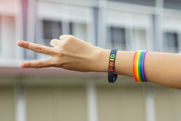 Raise your hand with a wristband and hold up two fingers to show your hope and pride for LGBT people.