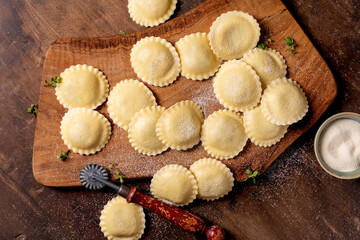 Fresh homemade ravioli on wooden board