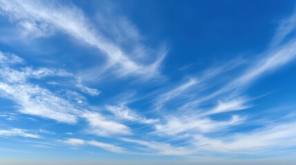 Fototapeta premium Vast blue skies with soft clouds, a tranquil and open panorama. A serene moment of calm and boundless freedom. 