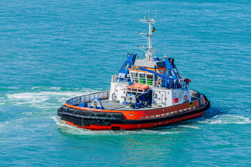Modern tugboat maneuvering in open sea