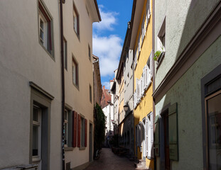 A charming, narrow alleyway in the historic old town of Konstanz (Constance), bathed in a mix of...