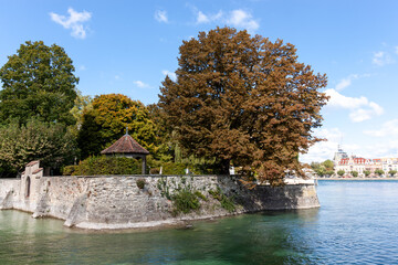 A picturesque view of the serene shoreline of Lake Constance (Bodensee) in Konstanz, Germany, under...
