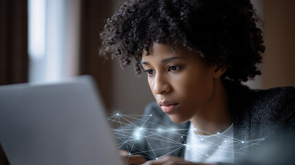 Focused woman working on a laptop with abstract network graphics overlayed, suggesting tech or data work.
