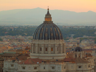 Golden sunrise over Vatican City with breathtaking view of St. Peter’s dome, soft mountain layers in background, harmony of faith, art, and history.