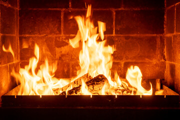 Closeup fire inside traditional fireplace, orange flames dancing, rustic home setting, cozy winter scene, warm lighting effect, evening cabin comfort