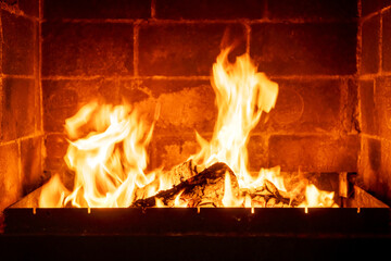 Closeup fire inside traditional fireplace, orange flames dancing, rustic home setting, cozy winter scene, warm lighting effect, evening cabin comfort