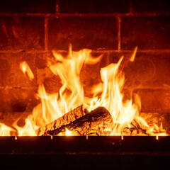 Crackling fire inside fireplace made of bricks, intense warmth and flame, romantic countryside interior scene, cozy home atmosphere