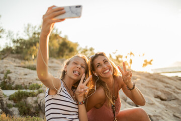 Two Female Friends Having Fun While Taking A Selfie At Summer Vacation