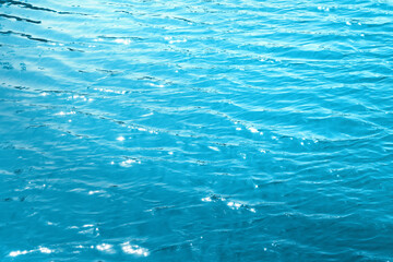 Blue water surface  in outdoor sea, sun reflection, dimply.  Water background. 