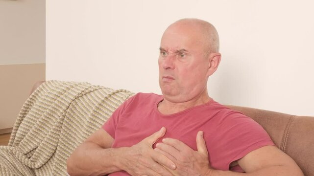 senior man holding chest in pain, sudden cardiac symptom, heart discomfort, possible rare cardiac condition, health risk, health emergency, panic attack