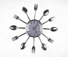 metal kitchen clock with forks and spoons isolated on white background
