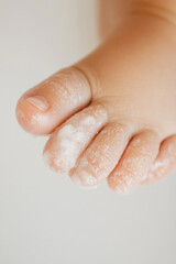 Fototapeta premium Close-up of a baby's foot with moisturizing cream applied to the sole