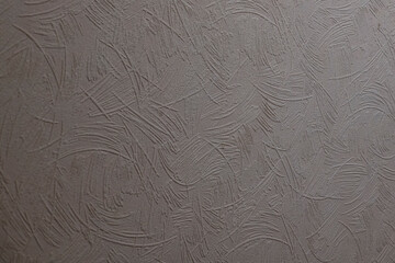 Gray textured background showing abstract patterns made up of curved and straight lines