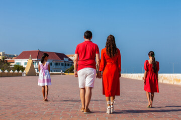 Young family of four traveling together. Family love concept. Travel concept. Cartagena de Indias.