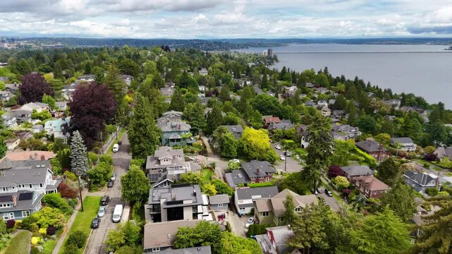 Flying high above a Seattle suburban neighborhood with a view of Lake Washington in the distance